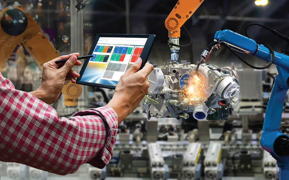Man holding tablet in front of fabrication machine