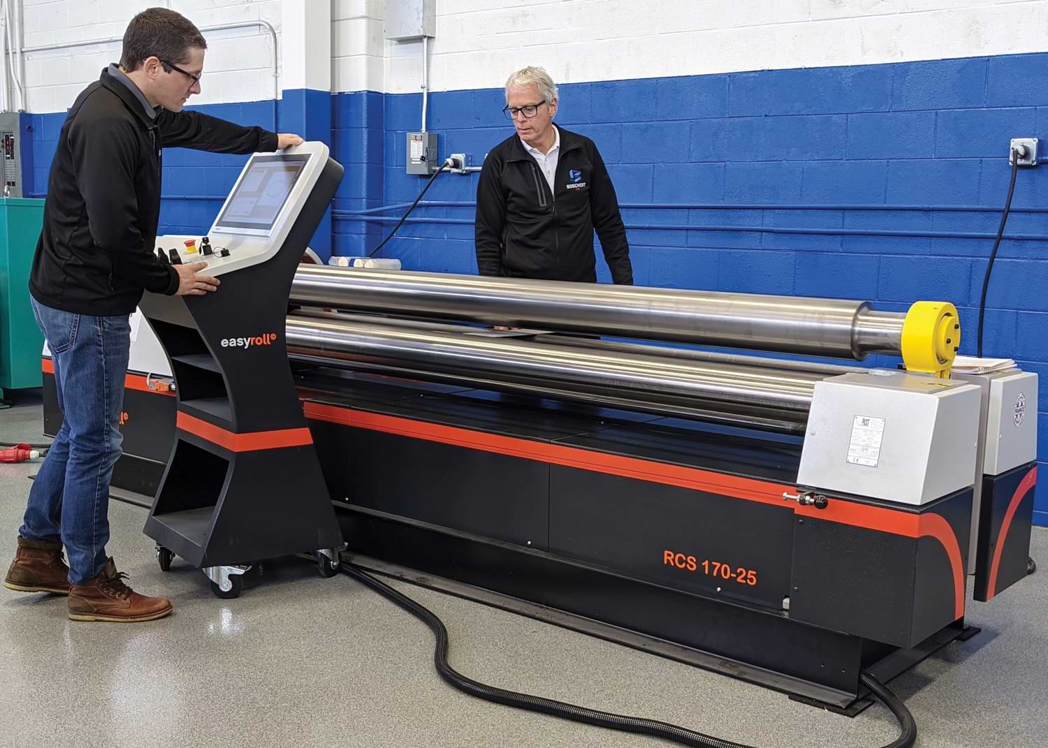 Boschert Precision Machinery Sales Director Tim Hoesly and President Greg Hoesly program the Picot 3-roll bending machine with the EasyRoll CNC control