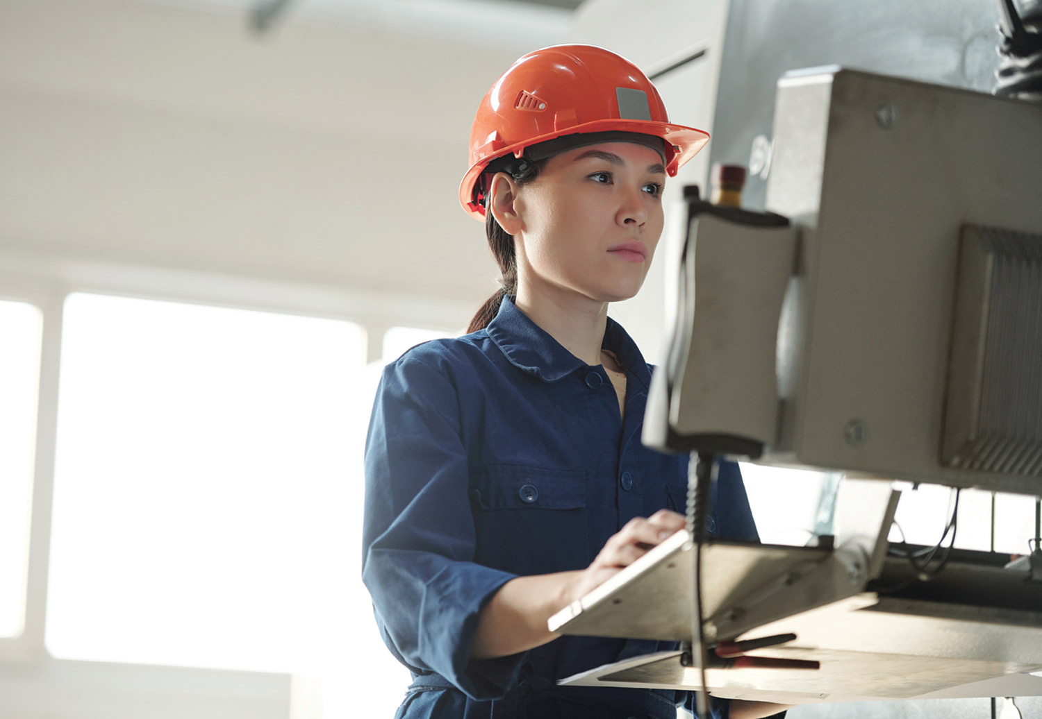 female factory worker at a computer