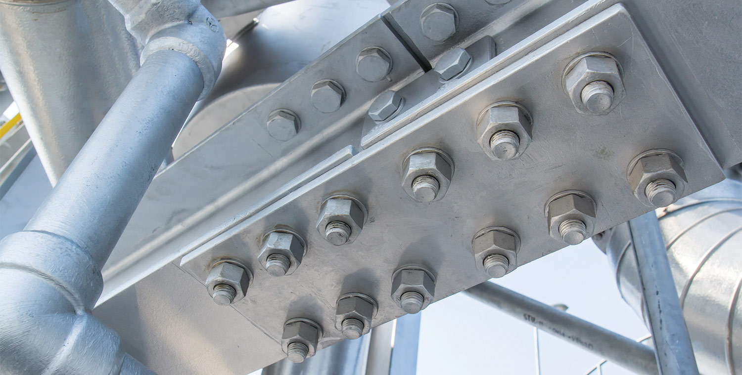 underview of a metal structure using large screws and bolts