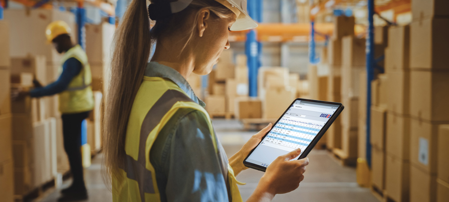 woman in warehouse working on tablet